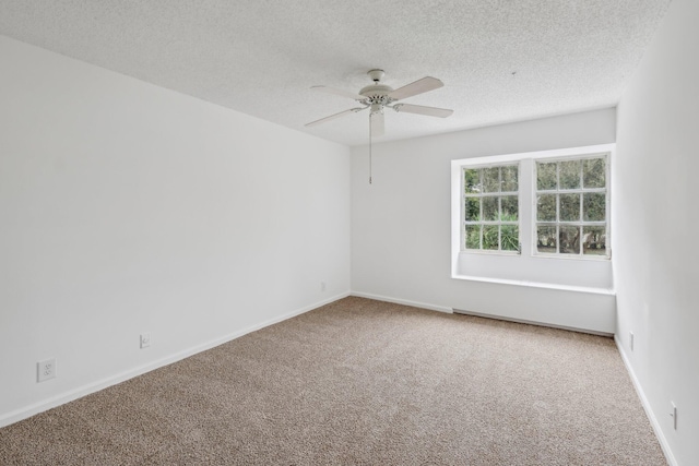 carpeted spare room featuring ceiling fan and a textured ceiling