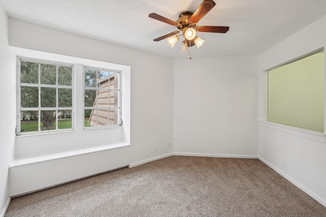 carpeted empty room featuring a textured ceiling and ceiling fan