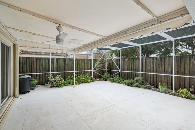 unfurnished sunroom with ceiling fan