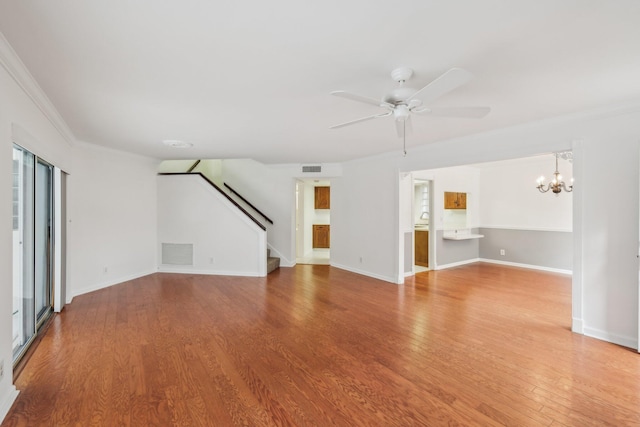 unfurnished living room with ornamental molding, ceiling fan with notable chandelier, and wood-type flooring