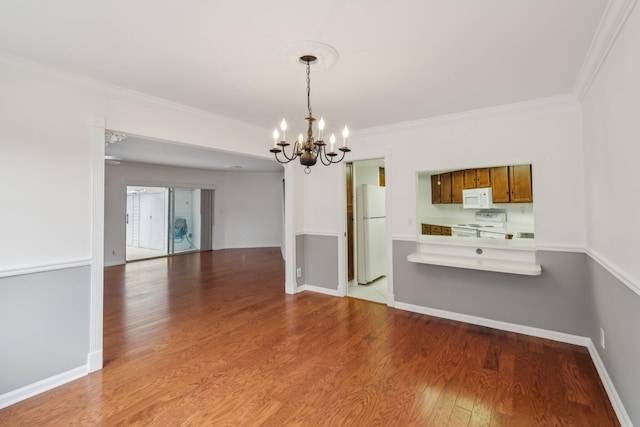 interior space with hardwood / wood-style flooring, crown molding, and a chandelier