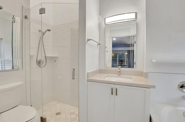 full bathroom featuring vanity, toilet, and separate shower and tub