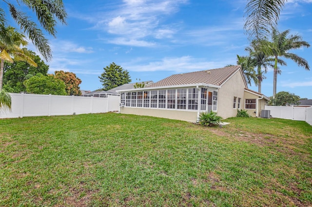 view of yard featuring central AC unit and a sunroom