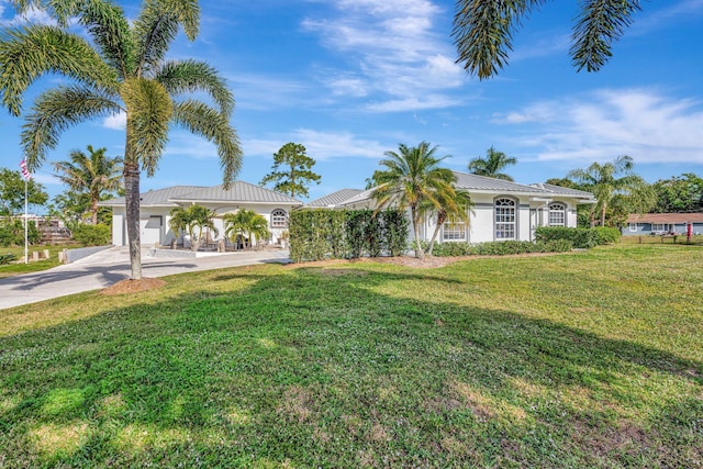 view of front of property with a front yard and a garage