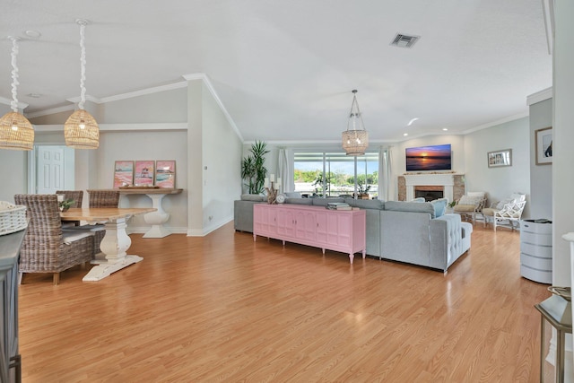 living room featuring light hardwood / wood-style floors and ornamental molding