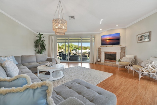 living room featuring ornamental molding, a premium fireplace, and hardwood / wood-style flooring