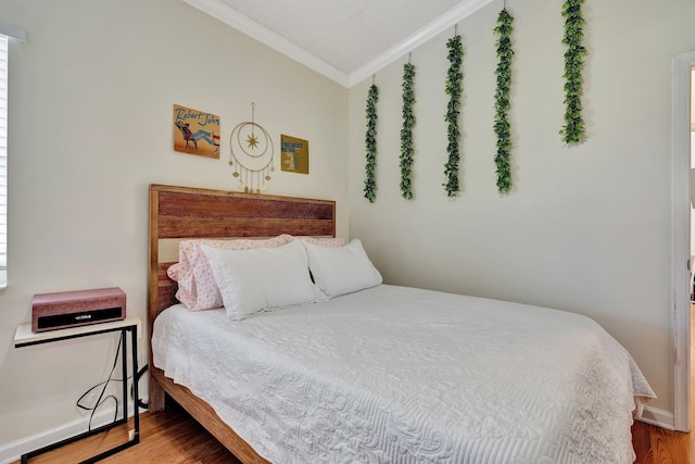 bedroom with crown molding and wood-type flooring