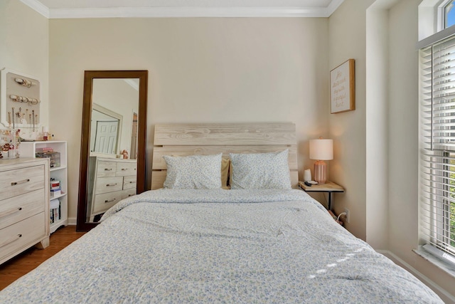 bedroom featuring crown molding, dark hardwood / wood-style flooring, and multiple windows