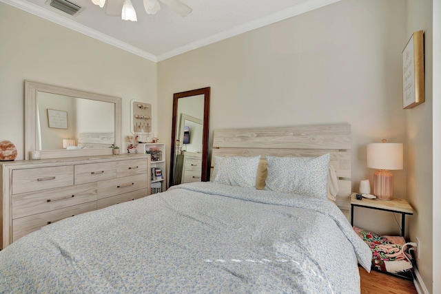 bedroom featuring ornamental molding, ceiling fan, and hardwood / wood-style flooring