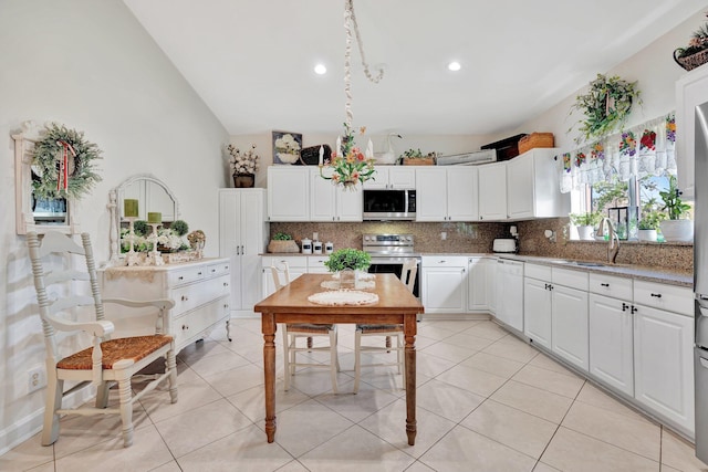 kitchen featuring sink, decorative backsplash, white cabinetry, and appliances with stainless steel finishes