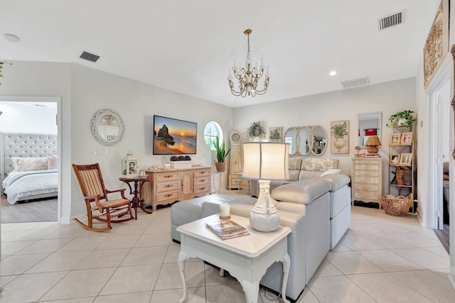 tiled living room with a notable chandelier