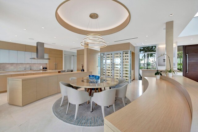 kitchen featuring a wall of windows, island range hood, plenty of natural light, and a large island