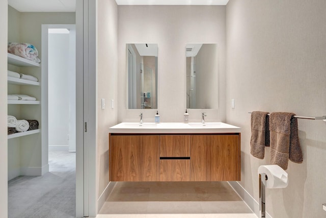 bathroom featuring built in shelves and vanity