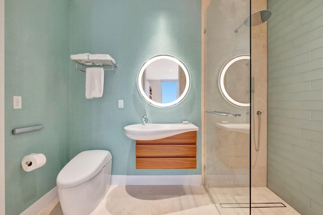 bathroom featuring vanity, toilet, and tiled shower