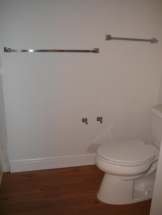 bathroom with hardwood / wood-style floors and toilet