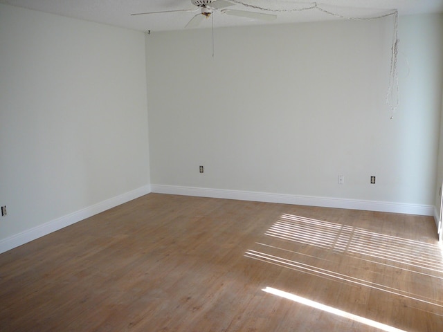 spare room with hardwood / wood-style floors and ceiling fan