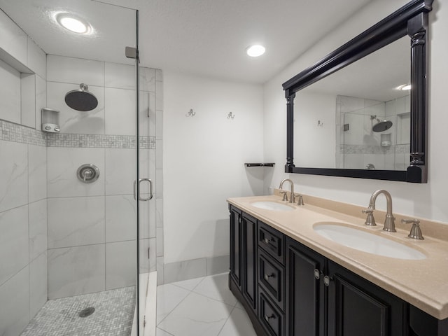 bathroom with a shower with door and vanity