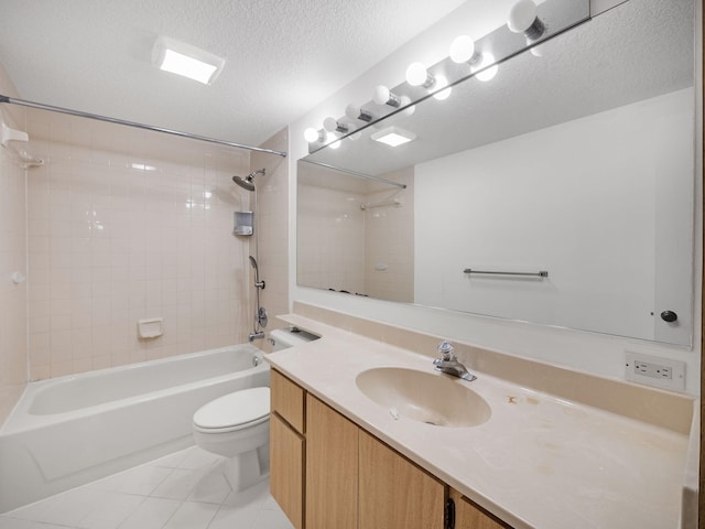 full bathroom featuring vanity, tile patterned floors, tiled shower / bath combo, toilet, and a textured ceiling