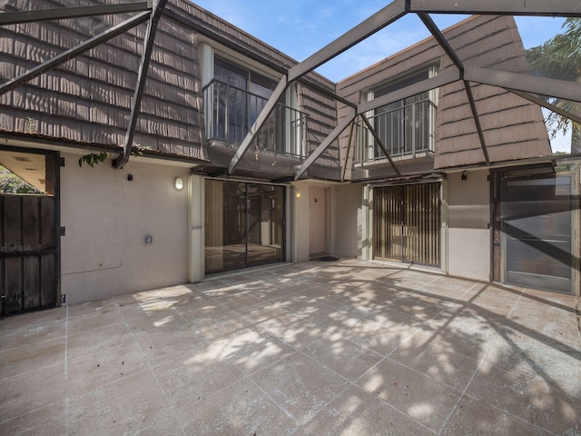 view of patio featuring a balcony