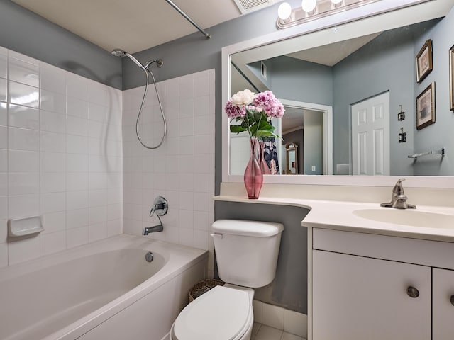 full bathroom with vanity, tiled shower / bath combo, and toilet