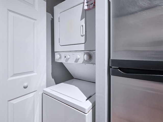 washroom featuring stacked washer and dryer