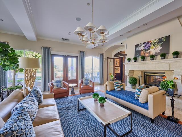 living room featuring a fireplace, beam ceiling, an inviting chandelier, and ornamental molding