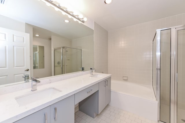 bathroom featuring tile patterned flooring, shower with separate bathtub, and vanity