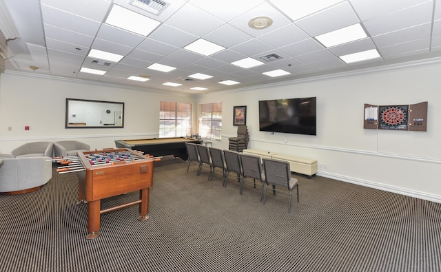 game room featuring a paneled ceiling, dark carpet, and crown molding