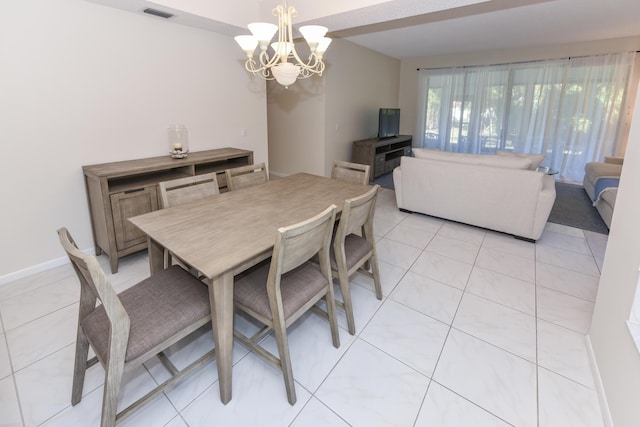 tiled dining area with a chandelier