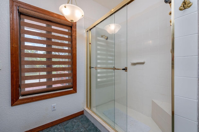 bathroom featuring a shower with shower door