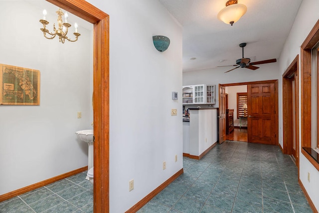 corridor featuring an inviting chandelier