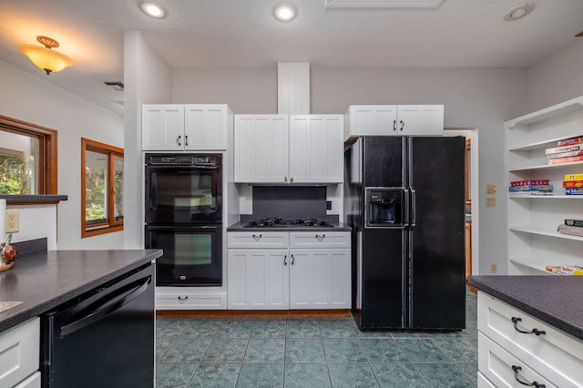 kitchen with white cabinetry, black appliances, and a textured ceiling