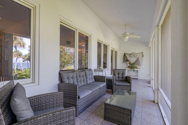 sunroom / solarium featuring a wealth of natural light, ceiling fan, and vaulted ceiling