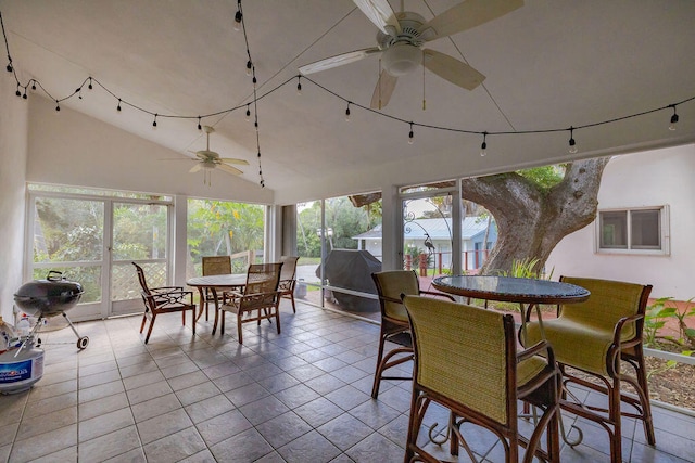 sunroom with vaulted ceiling, ceiling fan, and a healthy amount of sunlight