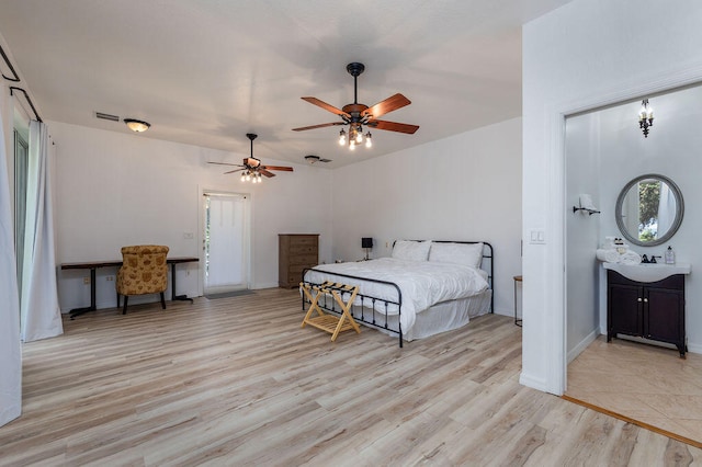 bedroom featuring ceiling fan, light hardwood / wood-style flooring, and sink