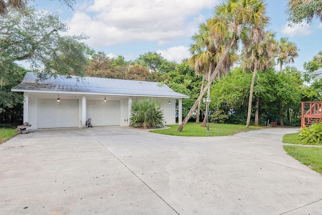 view of front of home with a front yard and a garage