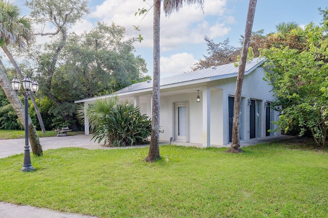 view of home's exterior with a lawn