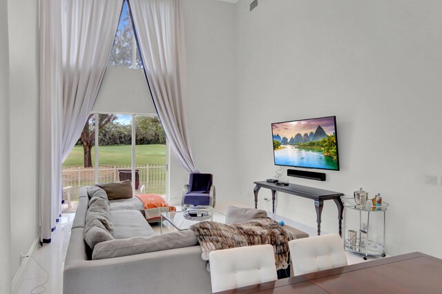 living room featuring a towering ceiling