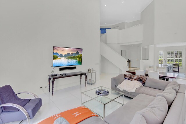 tiled living room with sink and a high ceiling