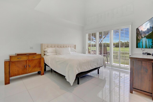 bedroom with light tile patterned floors and access to outside