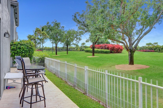 deck featuring a patio area and a yard