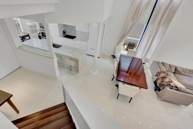 living room featuring sink and tile patterned flooring