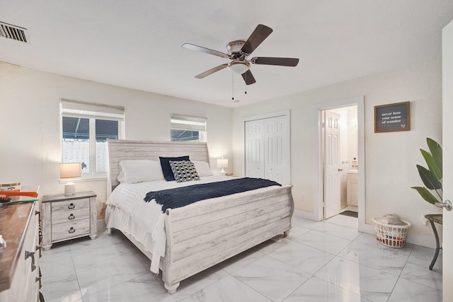 bedroom with ceiling fan, ensuite bathroom, and a closet