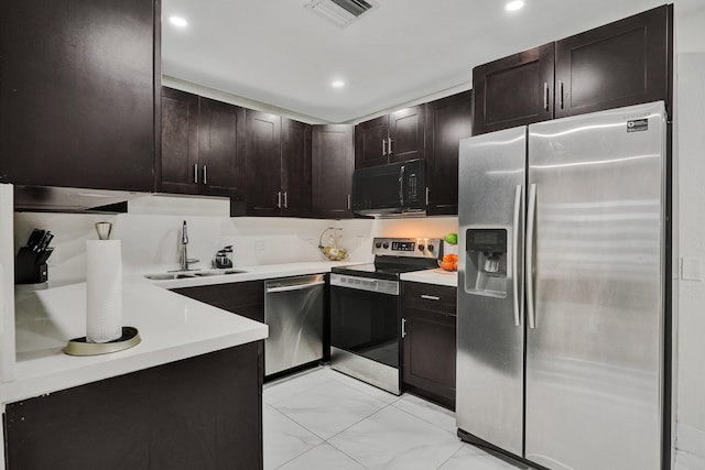 kitchen with dark brown cabinets, sink, and stainless steel appliances