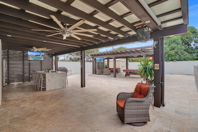 view of patio / terrace featuring a pergola, ceiling fan, and exterior bar