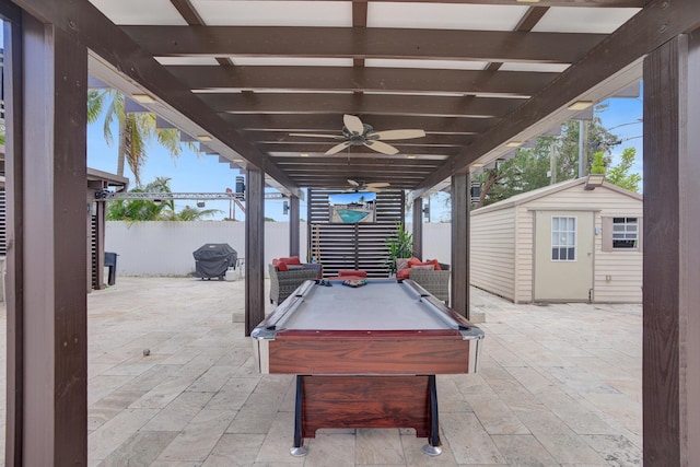 view of patio / terrace with area for grilling, a storage unit, and ceiling fan