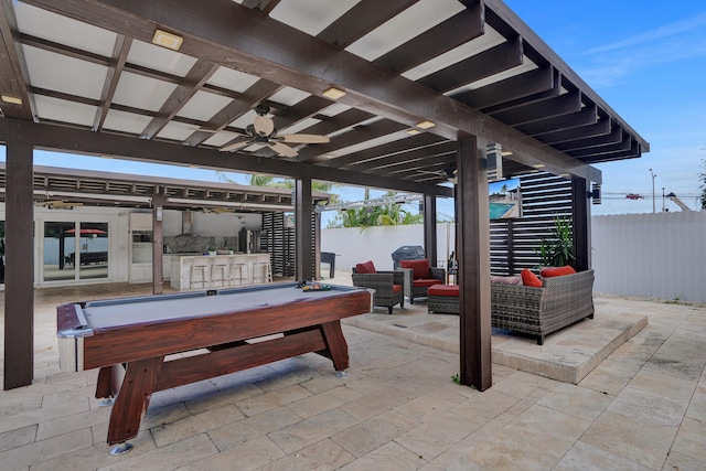 view of patio / terrace featuring outdoor lounge area, ceiling fan, and an outdoor bar