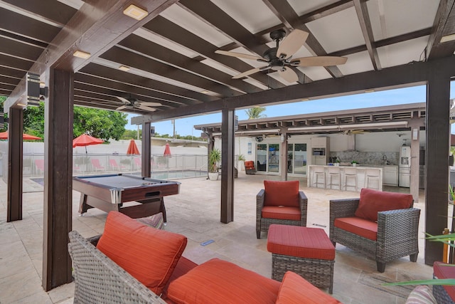 view of patio / terrace with ceiling fan and exterior bar