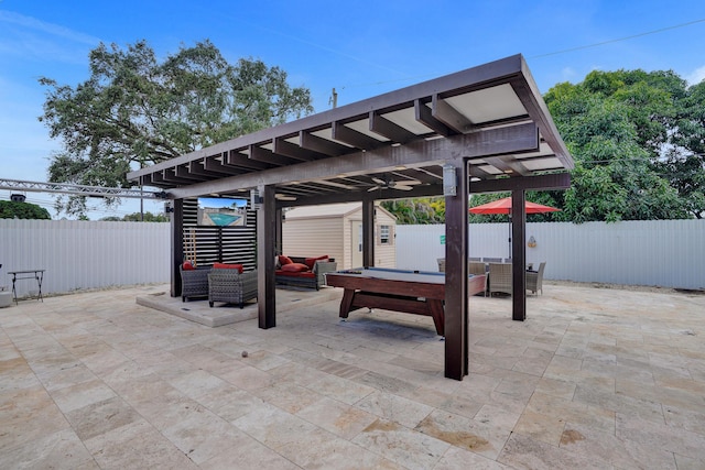 view of patio with outdoor lounge area and a storage shed