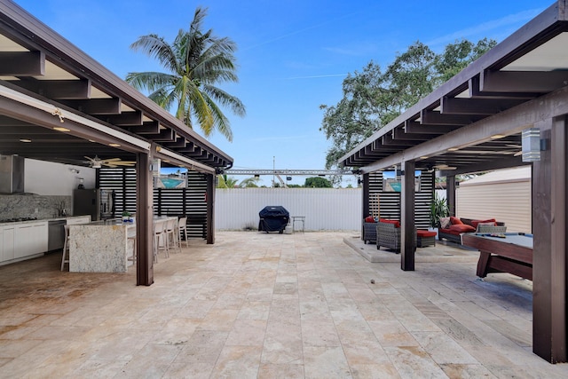 view of patio / terrace with an outdoor hangout area, area for grilling, and an outdoor bar